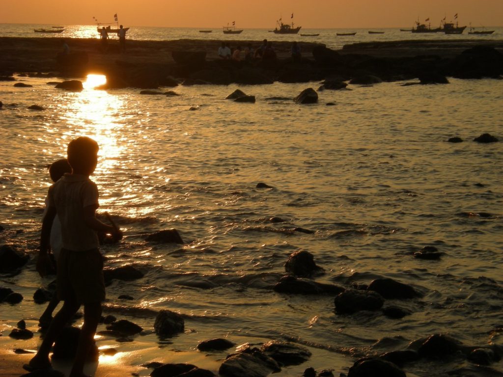 Kids playing cricket on beach